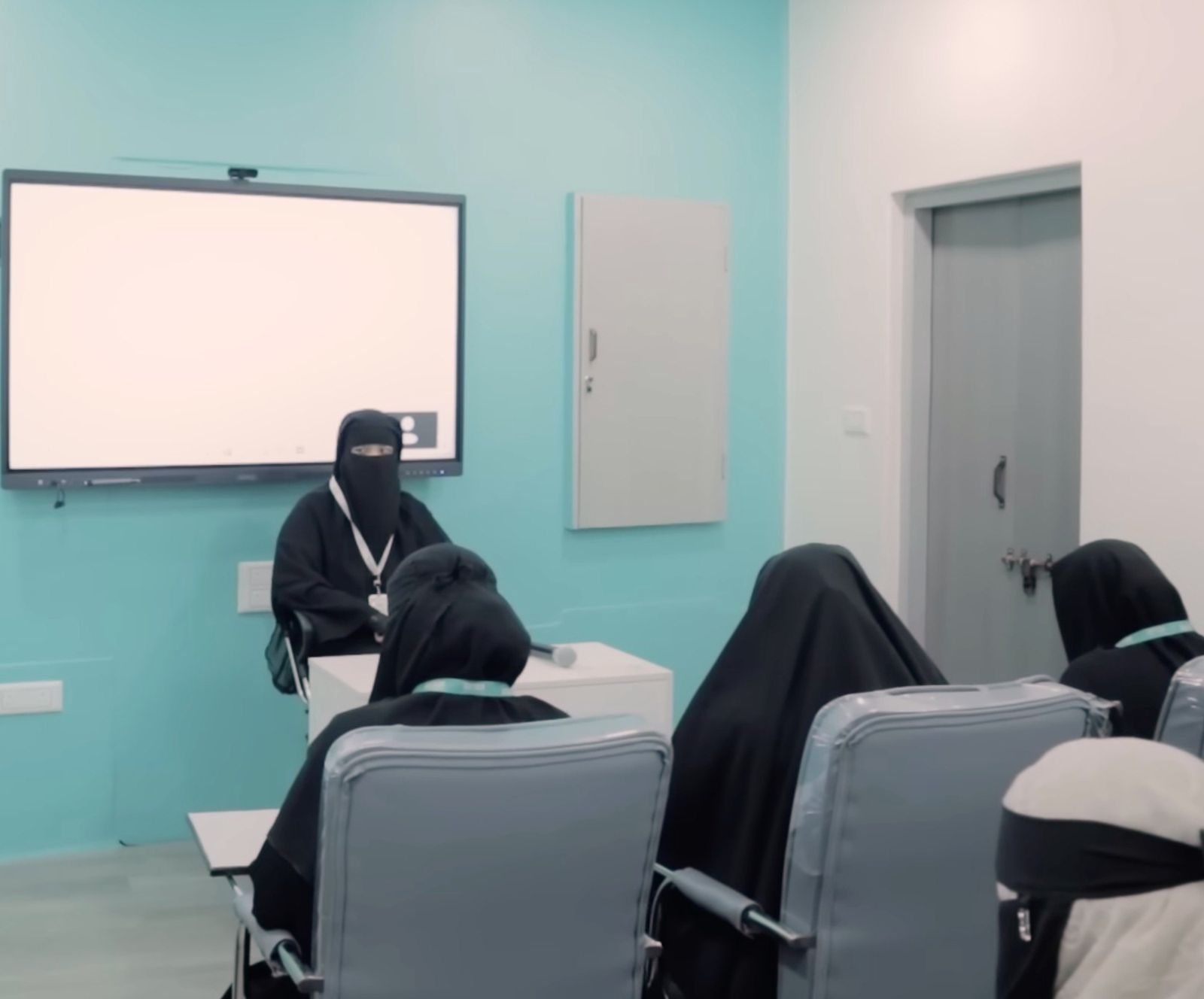 Female students in an Alimiyat Plus classroom with an interactive panel